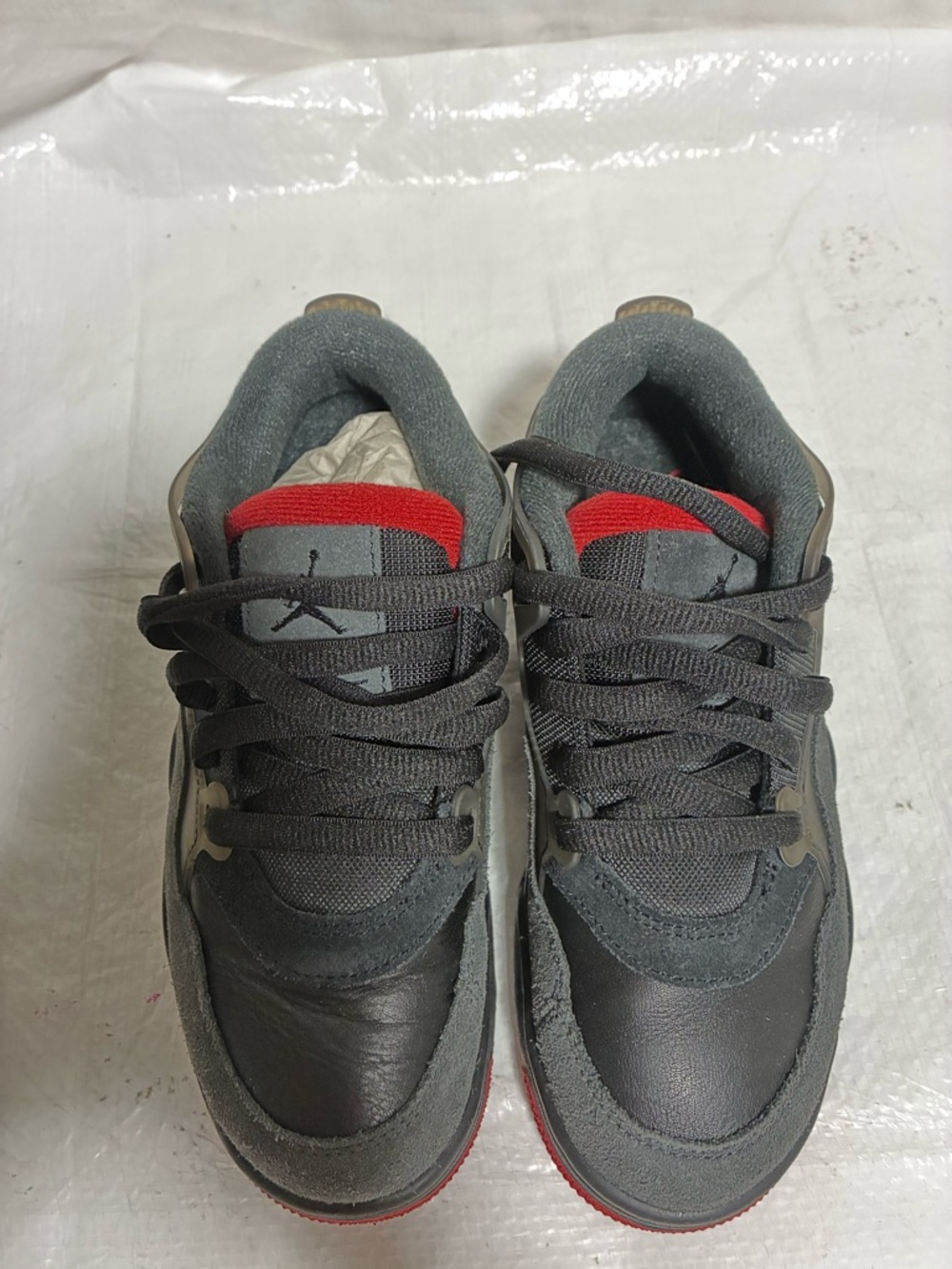 These are the Nike Air Jordan 4 RM GS in the "Black Red" or "Bred" colorway.